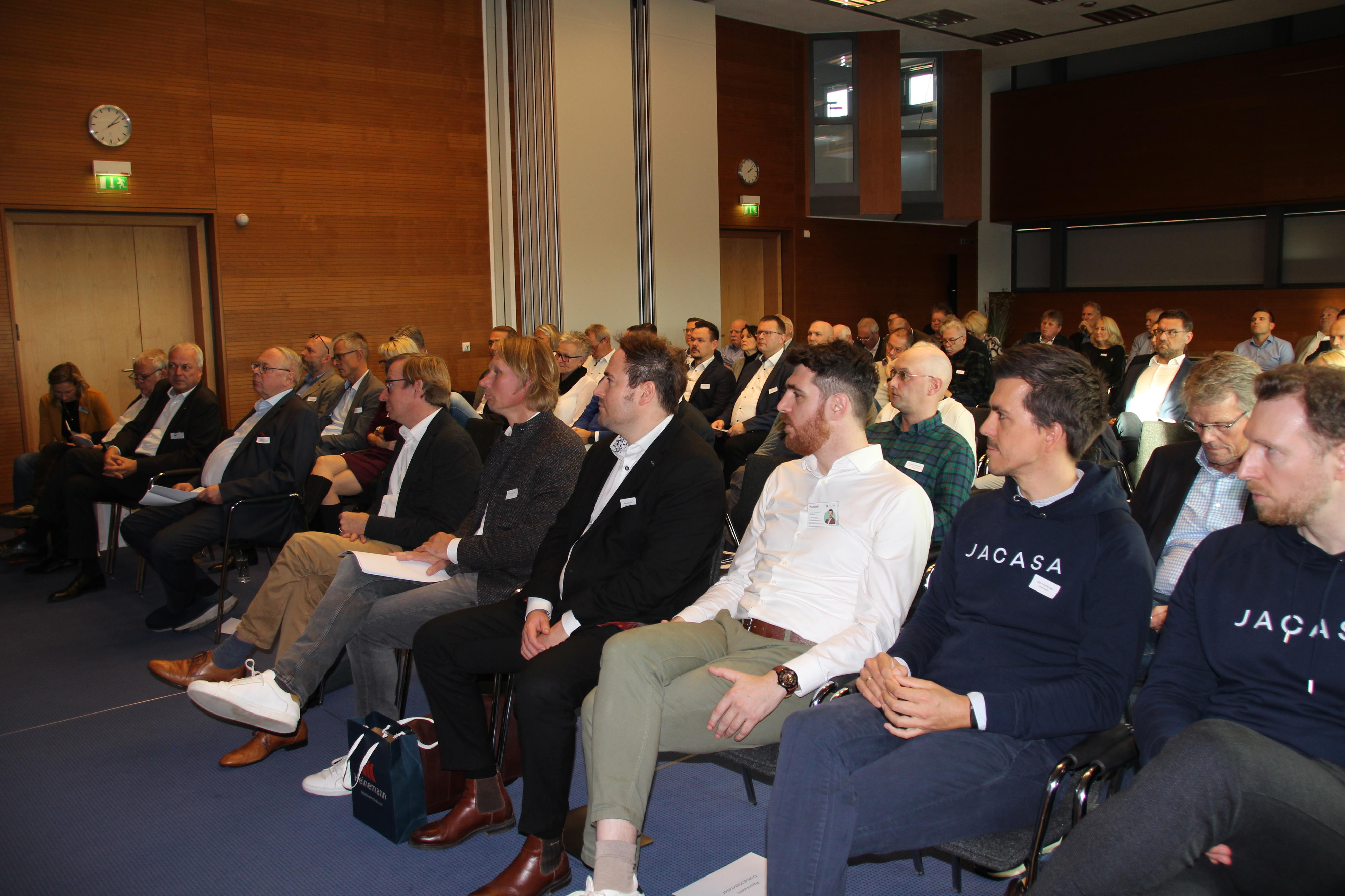 Viele Zuschauer sitzen im Saal Mecklenburg der IHK zu Rostock und schauen nach vorn zum Podium.