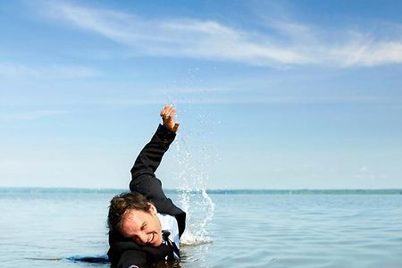Unternehmer im Wasser mit Rettungsreifen