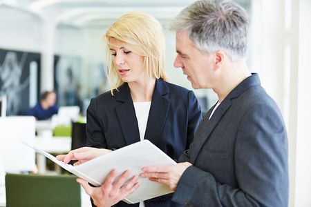 Ein Mann und eine Frau sehen sich Dokumente an