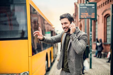 Businessman on the phone at bus station