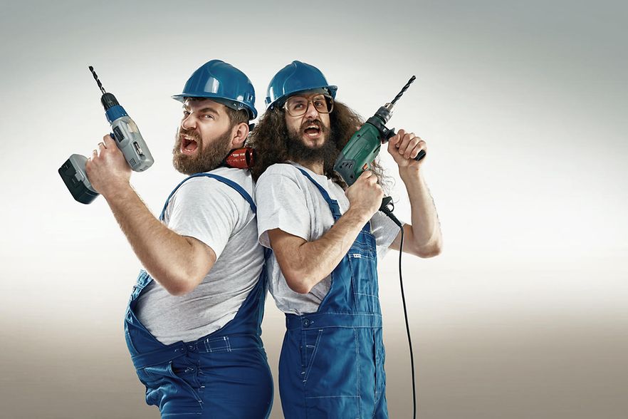 Funny portrait of two craftsmen_107191553