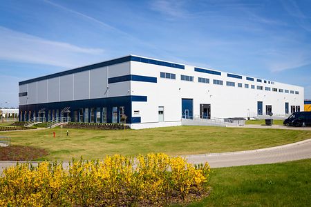 Drive way to large distribution warehouse building