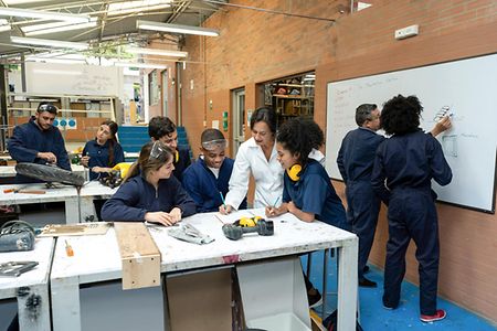 Group of students working with teachers at a design workshop
