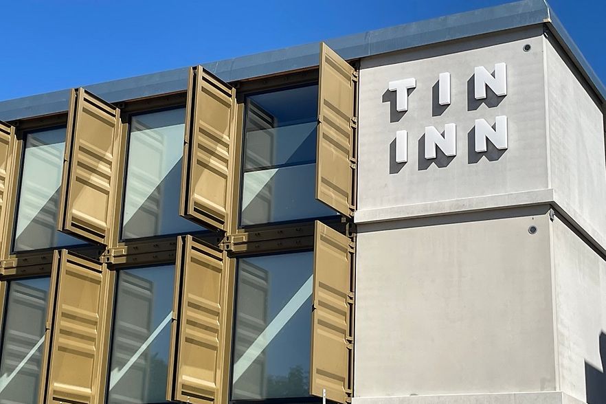 Viele &Uuml;berseecontainer &uuml;bereinander und nebeneinander gestellt mit Aufschrift Tin Inn
