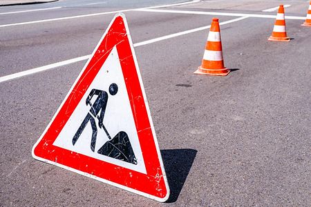 Men,At,Work,Sign,At,A,Construction,Site,-,Photo