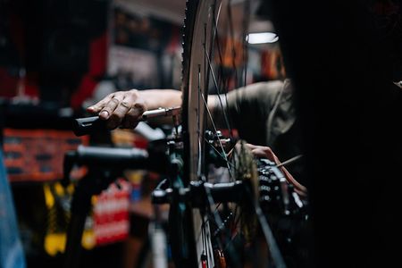 Close-up,Hands,Of,Unrecognizable,Repairman,Repairing,Mountain,Bike,Using,Special