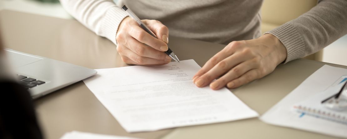 Woman,Signing,Document,,Focus,On,Female,Hand,Holding,Pen,,Putting