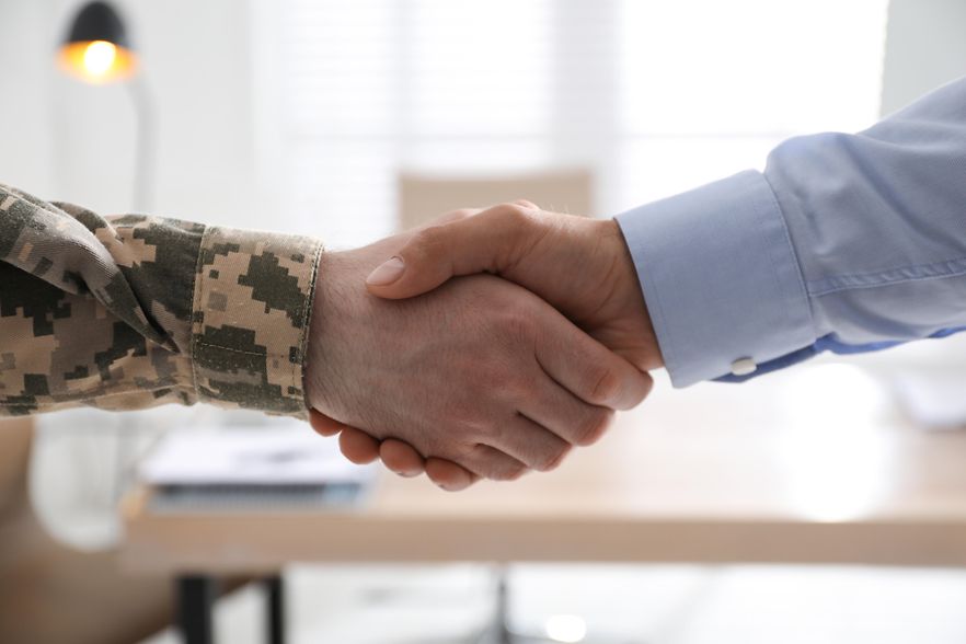 Soldier,And,Businessman,Shaking,Hands,Indoors,,Closeup
