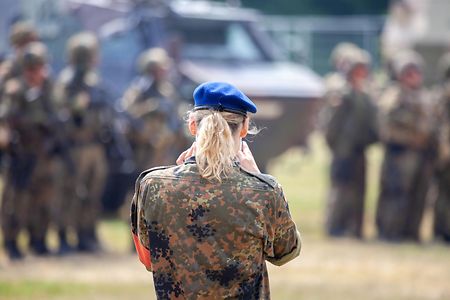 German soldier makes a handy photo from soldiers near military vehicles on a open day on day of the Bundeswehr in Feldkirchen