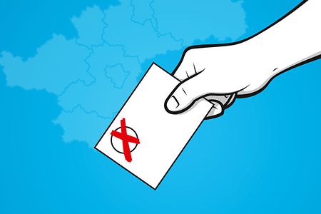 Hand mit Wahlkarte