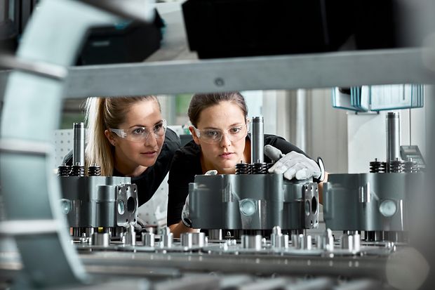 Young women checking production line on a conveyor belt