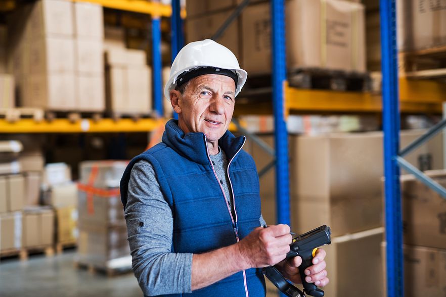Portrait of a senior male warehouse worker or a supervisor.