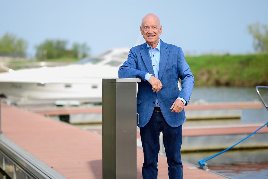 Peter Schneeberg steht auf dem Steg, im Hintergrund ist ein Sportboot zu sehen.