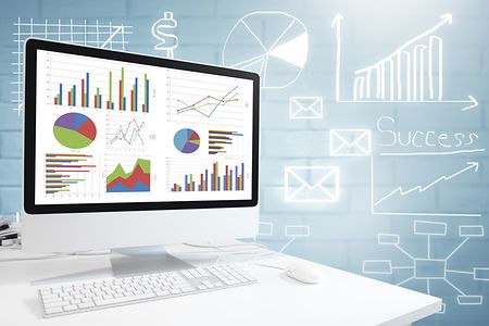 Modern computer with keyboard and mouse on table showing charts and graph, Analysis Business, Statistics Concept.