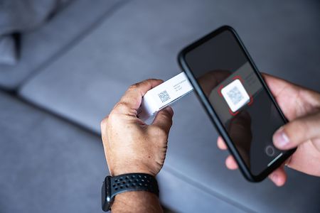 A man scanning data matrix / barcode on the medicine box with smartphone