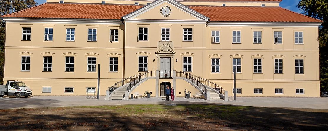 Ein Schloss mit hellgelber Fassade.