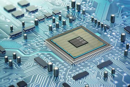 Intricate design of a computer chip on a circuit board surrounded by electronic components